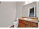 Cozy half-bathroom featuring wood vanity and bright lighting at 6645 Crest Wood Ln, Douglasville, GA 30135