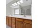 Bathroom with double sinks, dark wood cabinets, a large mirror, and a glass-enclosed shower at 6645 Crest Wood Ln, Douglasville, GA 30135
