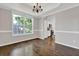 Dining room with elegant trim, chandelier, large window and hardwood floors at 6645 Crest Wood Ln, Douglasville, GA 30135