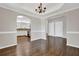 Elegant dining room boasts hardwood floors, chandelier, and open archways leading to other areas of the home at 6645 Crest Wood Ln, Douglasville, GA 30135