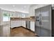 Kitchen featuring stainless steel refrigerator and appliances, white cabinets, and hardwood floors at 6645 Crest Wood Ln, Douglasville, GA 30135