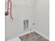 Functional laundry room with tiled floors and a utility sink at 6645 Crest Wood Ln, Douglasville, GA 30135