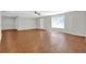 Expansive living room with hardwood floors, neutral walls, and a ceiling fan, perfect for entertaining at 6645 Crest Wood Ln, Douglasville, GA 30135
