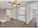 Cozy loft space featuring neutral carpeting, a ceiling fan, and a railing overlooking the lower level at 6645 Crest Wood Ln, Douglasville, GA 30135