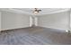 Large main bedroom boasting plush carpet, tray ceilings, and an ensuite bathroom entrance at 6645 Crest Wood Ln, Douglasville, GA 30135