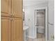 Bathroom with a wooden cabinet, pedestal sink, and a separate room for toilet and bathtub at 850 Piedmont Ne Ave # 3304, Atlanta, GA 30308