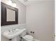 Powder room with traditional sink, mirror and wainscotting at 850 Piedmont Ne Ave # 3304, Atlanta, GA 30308