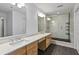 Bathroom featuring double sinks, quartz countertops, wood cabinets and a marble shower at 850 Piedmont Ne Ave # 3304, Atlanta, GA 30308