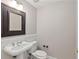Cozy powder room features classic pedestal sink and decorative mirror at 850 Piedmont Ne Ave # 3304, Atlanta, GA 30308
