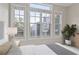 Bright bedroom featuring large windows with blinds, neutral walls, and a view of the city at 850 Piedmont Ne Ave # 3304, Atlanta, GA 30308