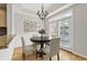 Bright dining area with backyard access, hardwood floors, chandelier, and adjacent kitchen at 850 Piedmont Ne Ave # 3304, Atlanta, GA 30308