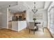 Bright dining area with hardwood floors, chandelier, and adjacent kitchen with stainless steel appliances at 850 Piedmont Ne Ave # 3304, Atlanta, GA 30308