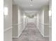 Long hallway with patterned carpet, neutral walls, and modern lighting at 850 Piedmont Ne Ave # 3304, Atlanta, GA 30308