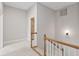 Carpeted hallway with wood railing leading to the upper level at 850 Piedmont Ne Ave # 3304, Atlanta, GA 30308