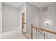 Upstairs hallway with neutral paint, carpet and oak railing leading to bedrooms at 850 Piedmont Ne Ave # 3304, Atlanta, GA 30308