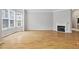 Living room with hardwood floors, a fireplace, and large windows providing natural light at 850 Piedmont Ne Ave # 3304, Atlanta, GA 30308