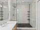 Modern shower with frameless glass door and marble-style tile at 850 Piedmont Ne Ave # 3304, Atlanta, GA 30308
