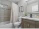 Bathroom featuring a tiled shower-tub, and stylish vanity with a framed mirror at 3180 Rehoboth Dr, Decatur, GA 30033