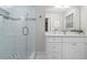 Bright bathroom featuring a glass shower, white vanity, tile floors, and a window at 3180 Rehoboth Dr, Decatur, GA 30033