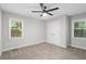 Spacious bedroom with neutral walls, carpet flooring, large closet, and natural light from two windows at 3180 Rehoboth Dr, Decatur, GA 30033