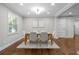 Dining room features hardwood floors, neutral paint, modern chandelier, and a large window at 3180 Rehoboth Dr, Decatur, GA 30033