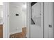 Hallway view of stacked laundry appliances and wood-look flooring at 3180 Rehoboth Dr, Decatur, GA 30033
