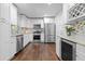 Modern kitchen features white cabinets, stainless steel appliances, granite countertops, and hardwood floors at 3180 Rehoboth Dr, Decatur, GA 30033
