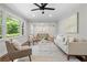Bright living room featuring hardwood floors, neutral paint, and large windows offer ample natural light at 3180 Rehoboth Dr, Decatur, GA 30033