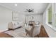Cozy living room features hardwood floors, neutral paint, ceiling fan, and large windows at 3180 Rehoboth Dr, Decatur, GA 30033