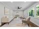 Well-lit living room features hardwood floors, neutral paint, ceiling fan, and large windows at 3180 Rehoboth Dr, Decatur, GA 30033