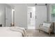 Stylish main bedroom featuring a sliding barn door to the bathroom, a chair, and neutral decor at 3180 Rehoboth Dr, Decatur, GA 30033