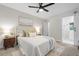 Cozy main bedroom features a ceiling fan, a comfortable bed and a sliding barn door to the bathroom at 3180 Rehoboth Dr, Decatur, GA 30033