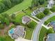 Aerial view of a beautiful home with a pool, golf course nearby, and lush landscaping at 388 Golf Crest Dr, Acworth, GA 30101