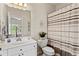 Bright bathroom with vanity, framed mirror, and tub with shower with a patterned curtain at 388 Golf Crest Dr, Acworth, GA 30101