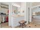 Bathroom with large vanity, walk-in closet, and entryway to the primary bedroom at 388 Golf Crest Dr, Acworth, GA 30101