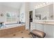 Bright bathroom features a soaking tub, vanity with ample storage and a walk-in closet at 388 Golf Crest Dr, Acworth, GA 30101