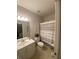 Well-lit bathroom with a single sink vanity and shower with striped curtain at 388 Golf Crest Dr, Acworth, GA 30101