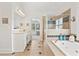 Luxurious bathroom with a soaking tub, glass enclosed shower, and double vanity sinks at 388 Golf Crest Dr, Acworth, GA 30101
