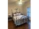 Charming bedroom featuring a wrought iron bed frame and neutral decor at 388 Golf Crest Dr, Acworth, GA 30101