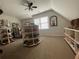 Attic walk-in closet with custom built-in shoe racks and shelving at 388 Golf Crest Dr, Acworth, GA 30101