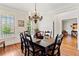 Elegant dining room with hardwood floors, chandelier, and plantation shutters for natural light at 388 Golf Crest Dr, Acworth, GA 30101