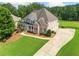 Stunning aerial view of the brick home featuring a spacious driveway and well-manicured lawn at 388 Golf Crest Dr, Acworth, GA 30101