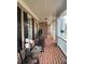 Inviting front porch with brick flooring, rocking chairs, and elegant columns at 388 Golf Crest Dr, Acworth, GA 30101