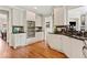 Well-appointed kitchen featuring custom cabinets, black countertops and backsplash, with hardwood flooring at 388 Golf Crest Dr, Acworth, GA 30101
