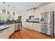 Modern kitchen with stainless steel appliances, granite countertops, and hardwood floors at 388 Golf Crest Dr, Acworth, GA 30101