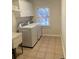 Functional laundry room with window, washer, dryer, and white cabinets at 388 Golf Crest Dr, Acworth, GA 30101