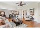 Open-concept living room with hardwood floors, a kitchen view, and a cozy seating area at 388 Golf Crest Dr, Acworth, GA 30101
