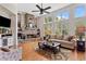 Inviting living room with stone fireplace, hardwood floors, large windows, and stylish decor at 388 Golf Crest Dr, Acworth, GA 30101