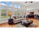 Bright living room featuring hardwood floors, large windows with shutters, and stylish furnishings at 388 Golf Crest Dr, Acworth, GA 30101
