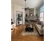 Cozy living room with stone fireplace and large windows overlooking a backyard at 388 Golf Crest Dr, Acworth, GA 30101